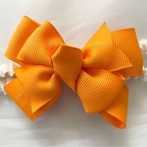 Orange bow on a stretchy gathered satin headband